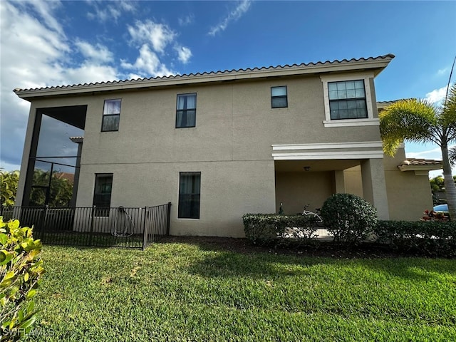 rear view of property with a lawn