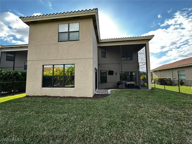 rear view of property with a patio and a lawn