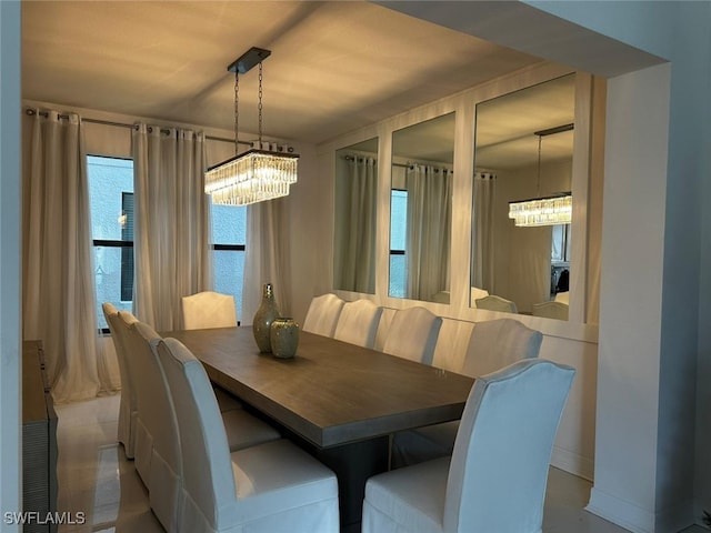 dining area featuring a wealth of natural light and a chandelier