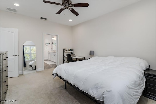 carpeted bedroom featuring ceiling fan and connected bathroom