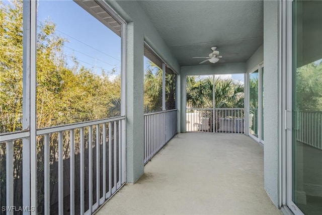 sunroom featuring ceiling fan