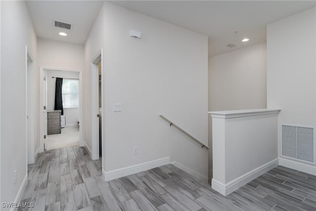 hall with light hardwood / wood-style floors