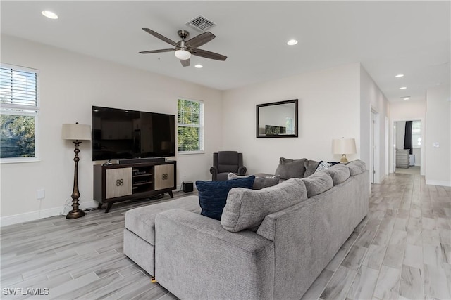 living room featuring light hardwood / wood-style floors and ceiling fan