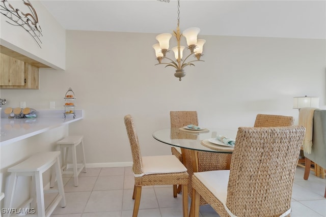 dining area with light tile patterned floors and a notable chandelier