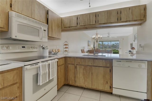 kitchen featuring light tile patterned flooring, sink, ceiling fan with notable chandelier, and white appliances