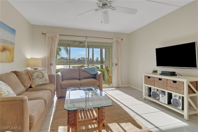 living area with light tile patterned floors, baseboards, and a ceiling fan