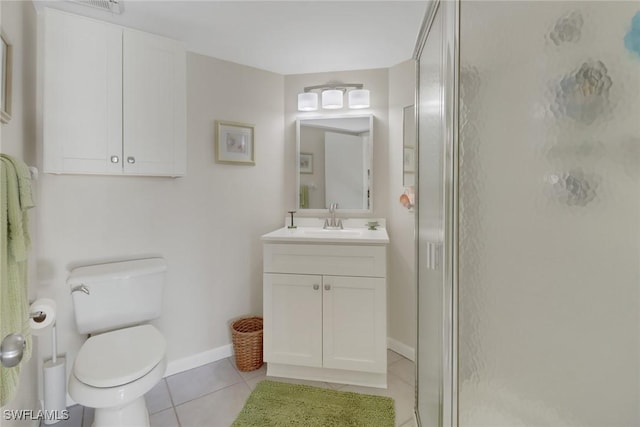 bathroom featuring tile patterned floors, toilet, a shower with shower door, and vanity