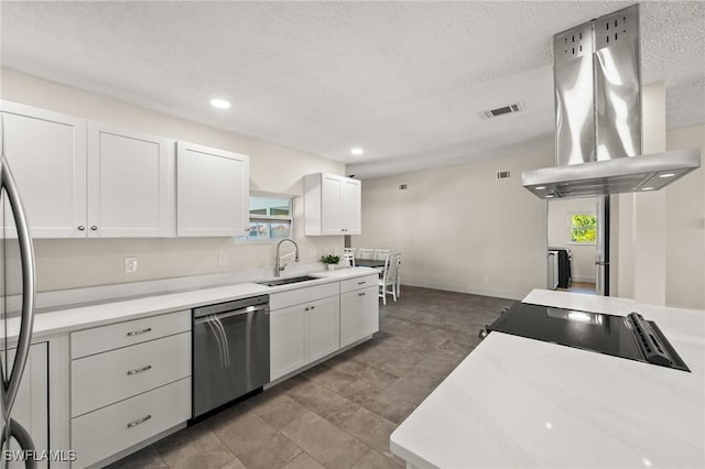 kitchen with island range hood, sink, white cabinets, stainless steel appliances, and a textured ceiling