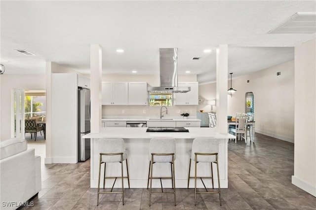 kitchen with white cabinetry, island exhaust hood, a center island, and sink