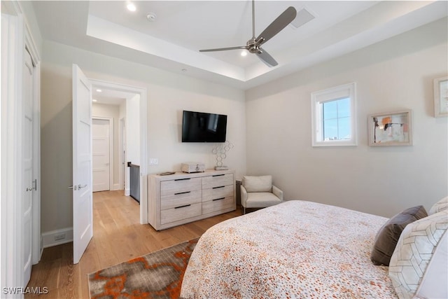 5997 Cypress Ln, Bonita Springs, FL 34134 - bedroom featuring a ceiling fan, baseboards, light wood finished floors, a tray ceiling, and recessed lighting