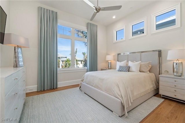 bedroom with ceiling fan and light wood-type flooring