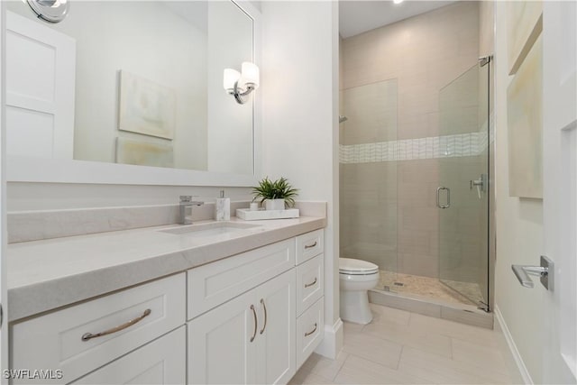 bathroom with vanity, toilet, tile patterned floors, and walk in shower