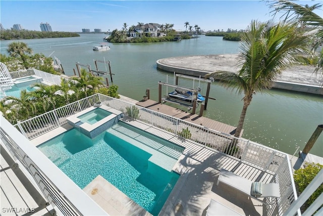 view of swimming pool featuring a water view, an in ground hot tub, and a boat dock