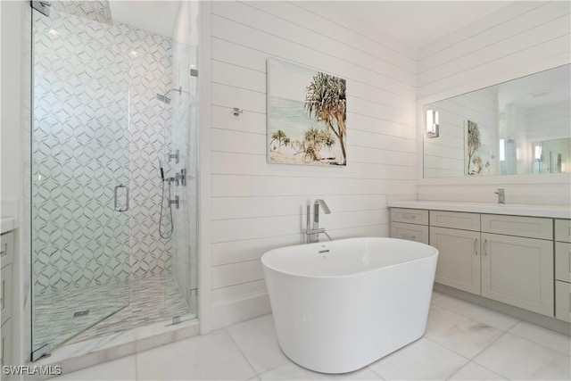 5997 Cypress Ln, Bonita Springs, FL 34134 - bathroom with a freestanding tub, tile patterned flooring, a shower stall, wood walls, and vanity