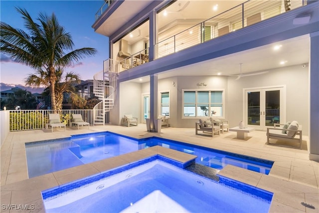 5997 Cypress Ln, Bonita Springs, FL 34134 - pool at dusk with ceiling fan, fence, french doors, stairs, and an in ground hot tub