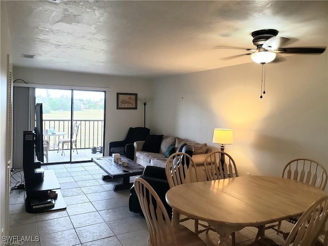 tiled dining area featuring ceiling fan