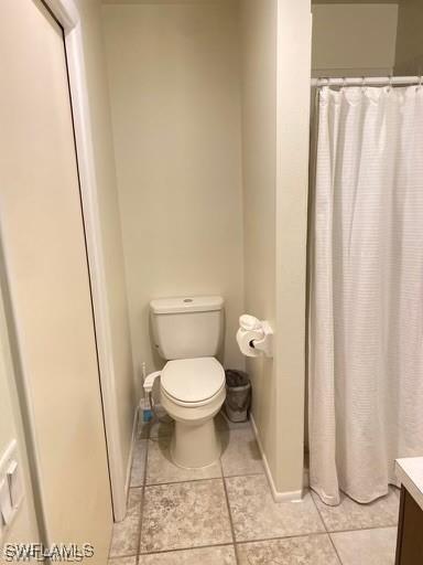 bathroom with vanity, tile patterned flooring, and toilet