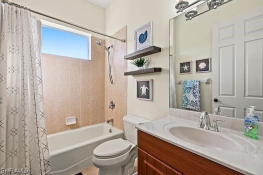 full bathroom with vanity, toilet, and shower / bath combo with shower curtain