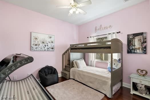 bedroom with dark hardwood / wood-style floors and ceiling fan