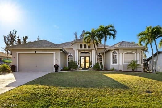 view of front of home featuring a garage and a front lawn