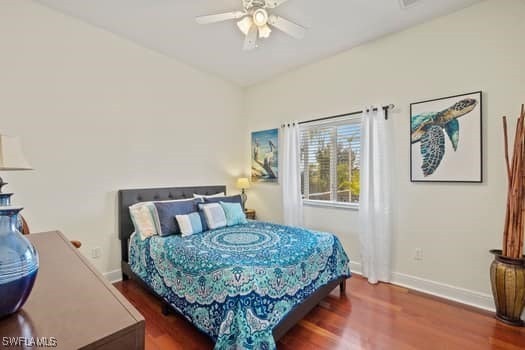 bedroom featuring dark wood-type flooring, ceiling fan, and lofted ceiling