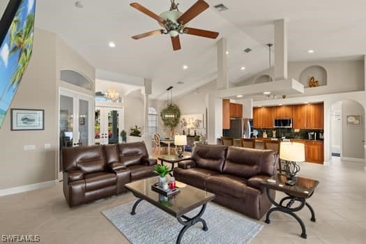 living room featuring high vaulted ceiling, french doors, and ceiling fan