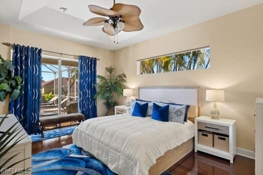 bedroom featuring dark wood-type flooring, ceiling fan, and access to exterior