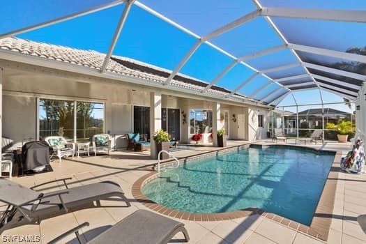 view of swimming pool with a lanai and a patio area