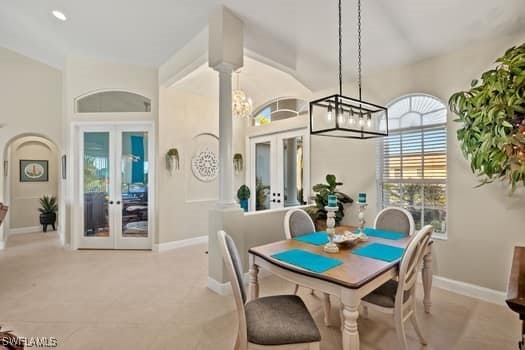 dining space with a chandelier and french doors