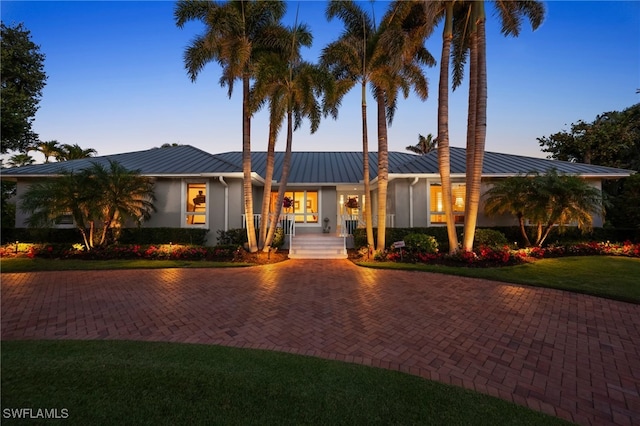 ranch-style home with a yard