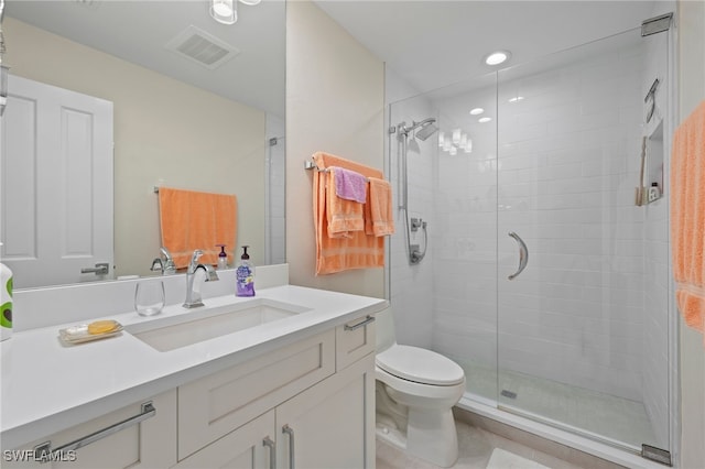 bathroom with toilet, vanity, and an enclosed shower