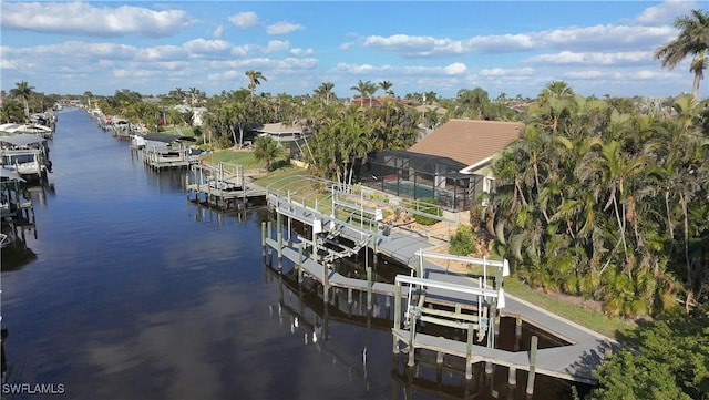 view of dock with a lanai and a water view