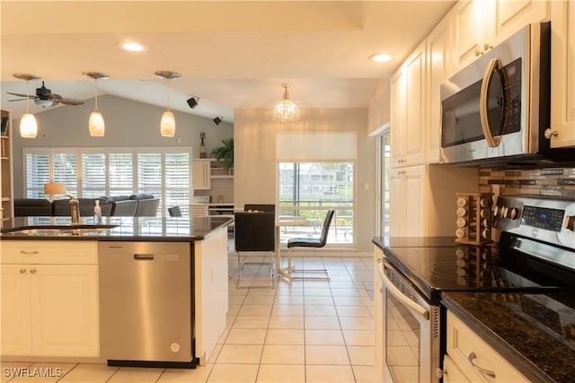 kitchen featuring appliances with stainless steel finishes, decorative light fixtures, and white cabinets