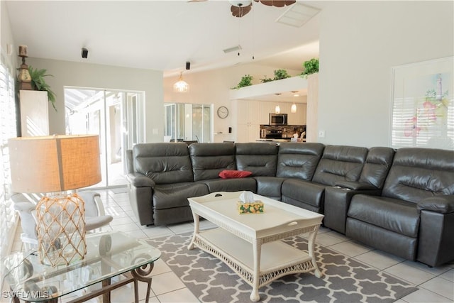 tiled living room featuring ceiling fan and lofted ceiling