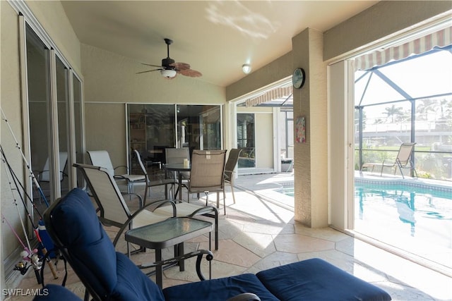 exterior space with ceiling fan and glass enclosure