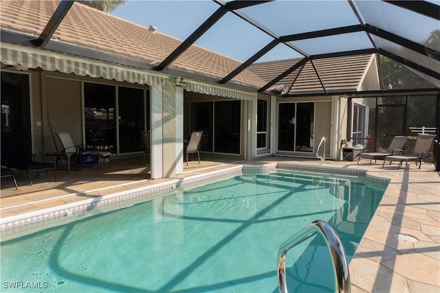 view of pool with a patio and a lanai