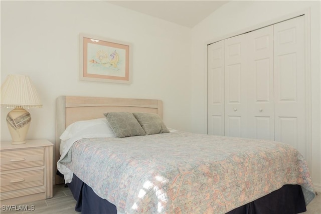 bedroom with light hardwood / wood-style floors and a closet