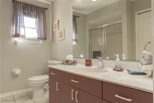 bathroom with vanity, toilet, tile patterned floors, and walk in shower