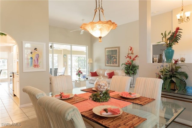 dining area with a notable chandelier and light tile patterned floors