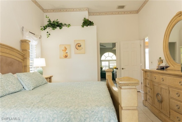 tiled bedroom featuring a high ceiling