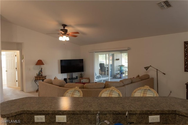 carpeted living room featuring vaulted ceiling and ceiling fan