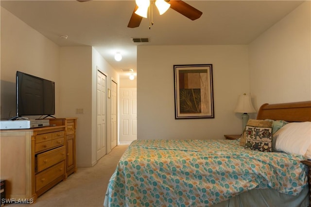 bedroom with ceiling fan and light colored carpet