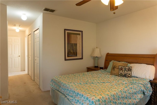 bedroom featuring light colored carpet, ceiling fan, and a closet