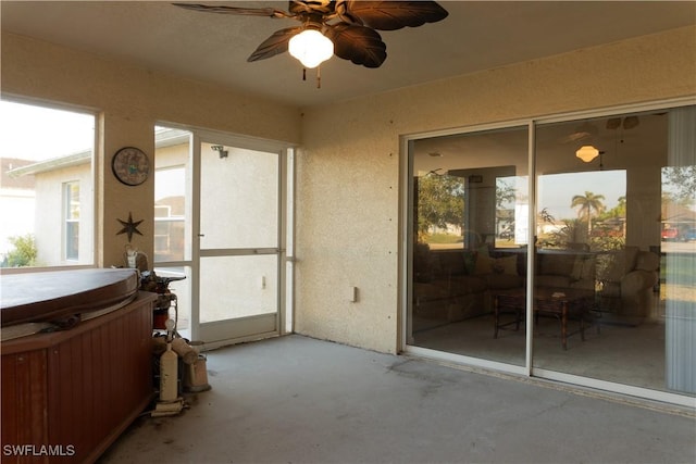 sunroom featuring ceiling fan