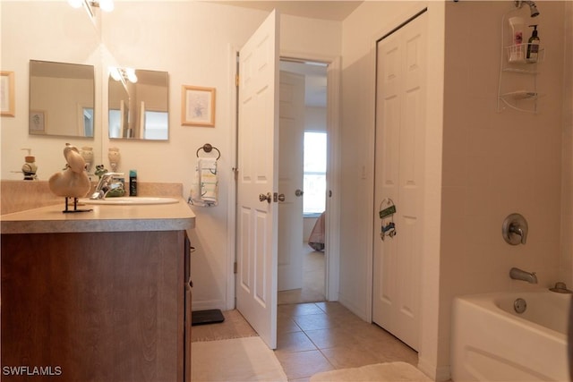 bathroom with vanity, tile patterned floors, and  shower combination