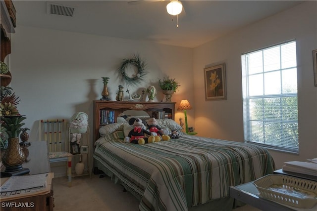 carpeted bedroom with radiator and ceiling fan