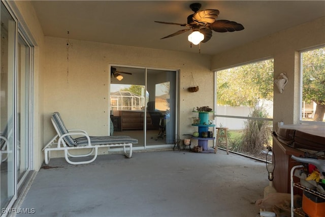 sunroom / solarium featuring ceiling fan