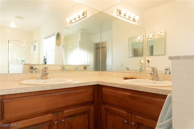 bathroom featuring vanity and a shower with door