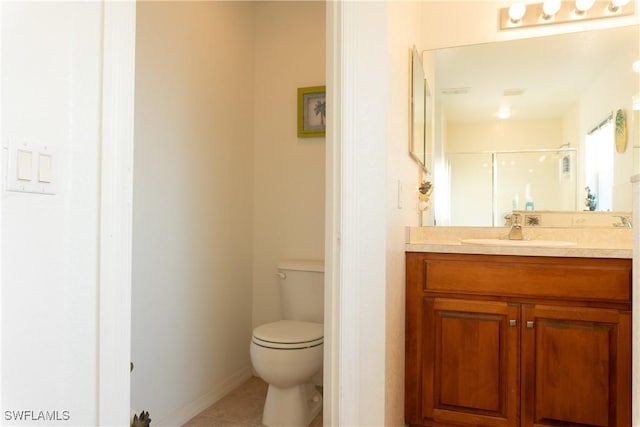 bathroom featuring a shower with door, vanity, tile patterned floors, and toilet