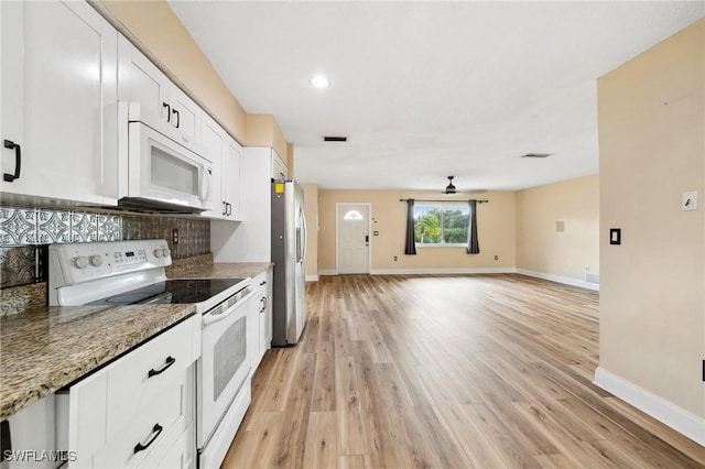 kitchen with white appliances, white cabinetry, baseboards, light wood-type flooring, and light stone countertops